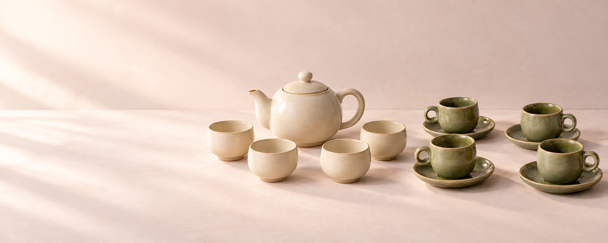 Ivory tea service and moss green espresso cups arranged as two gift choices