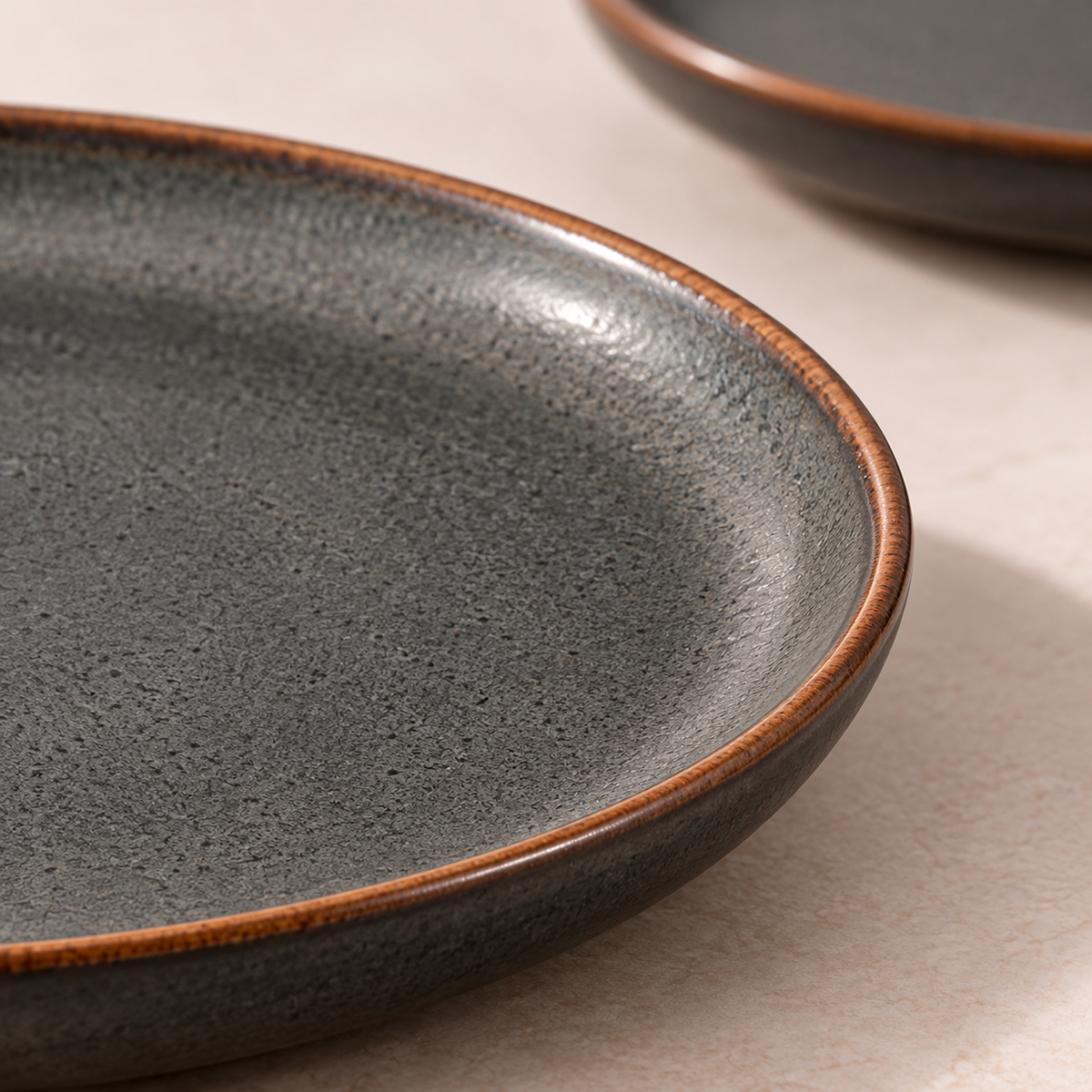 Ember Halo Dinnerware Set in charcoal with rust-brown rim — shape and glaze detail